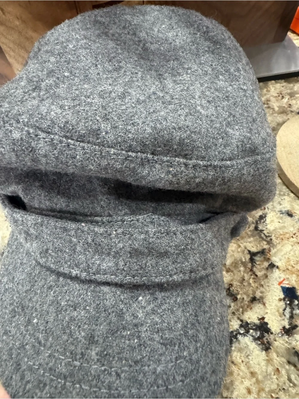 Gray newsboy cap features a felted wool blend material (CL-3)